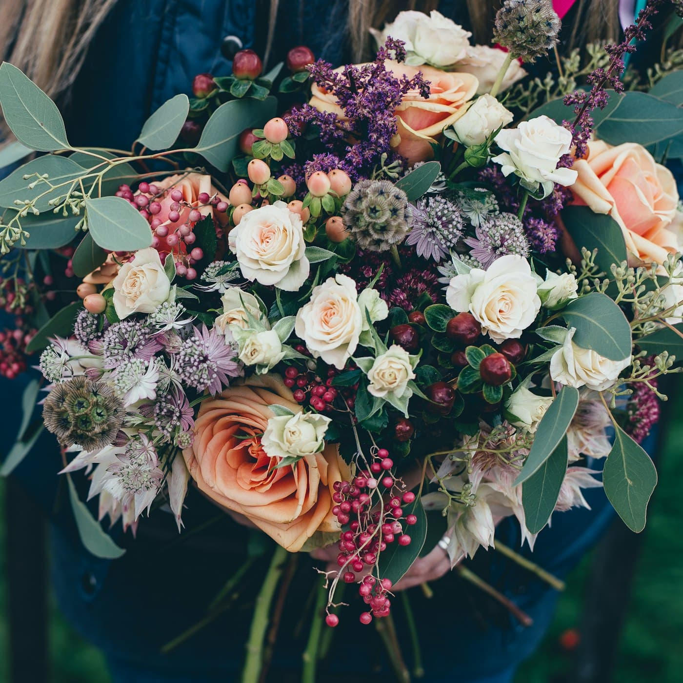 A mixed bouquet of roses and greenery