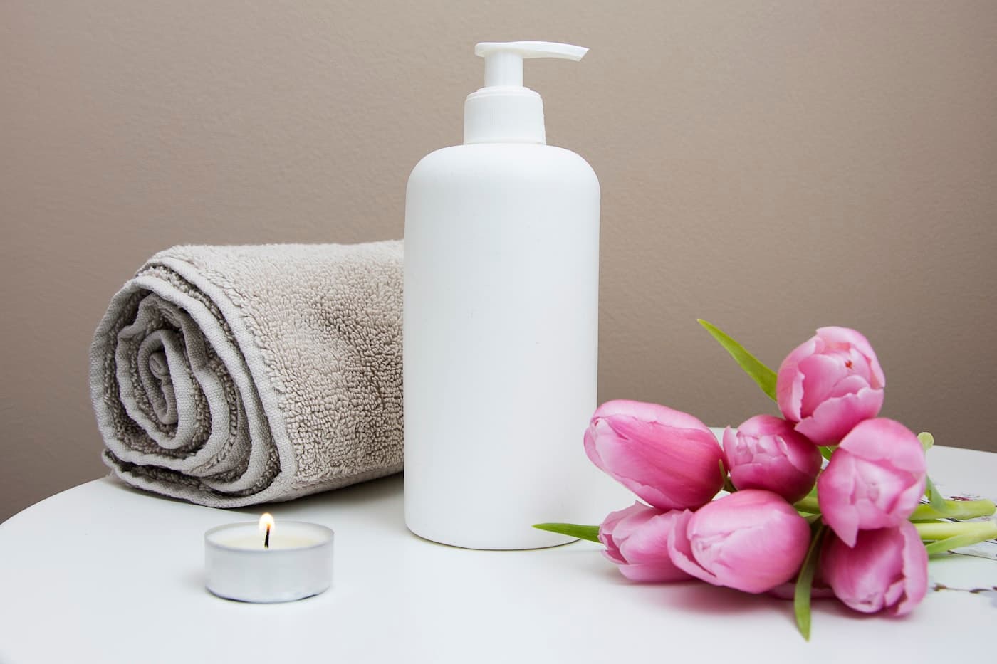 Wellness towel, lotion, and flowers