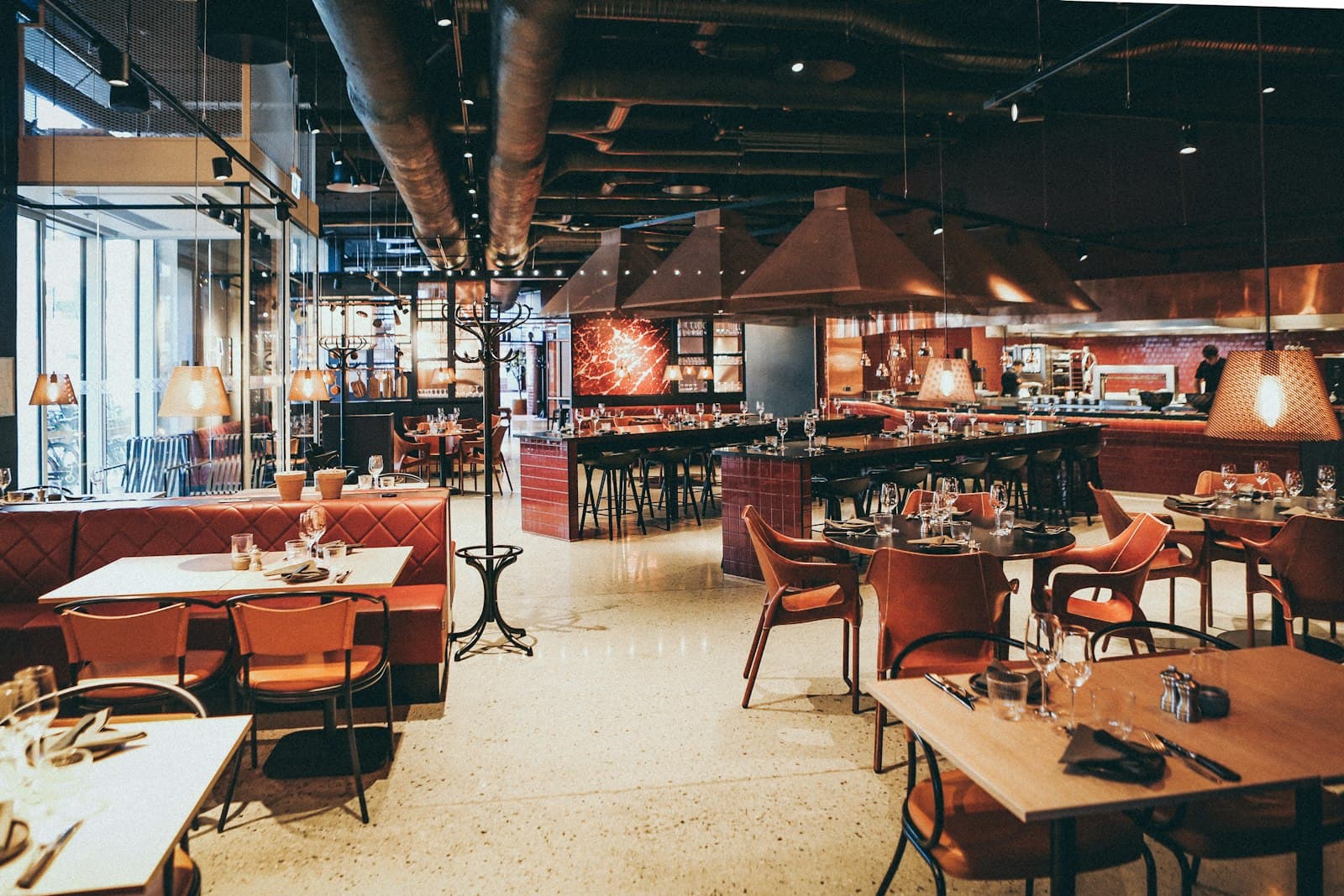 A modern restaurant dining room and open kitchen
